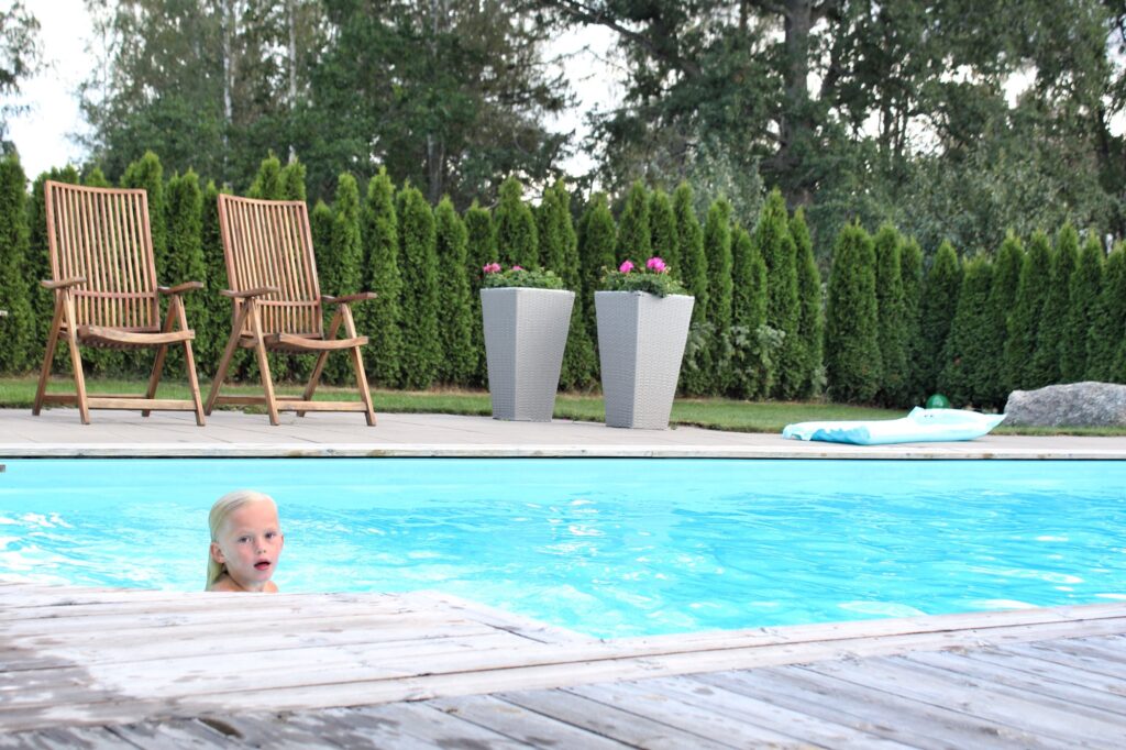 Boy swimming in a pool in a garden